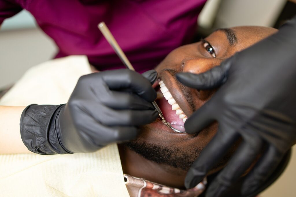 Dentist examining the gums of a patient with diabetes during a routine dental visit